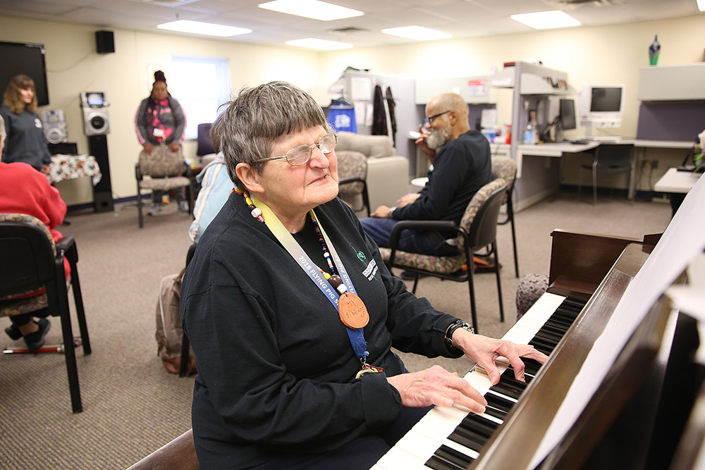 woman who is visually impaired playing piano at Clovernook Center